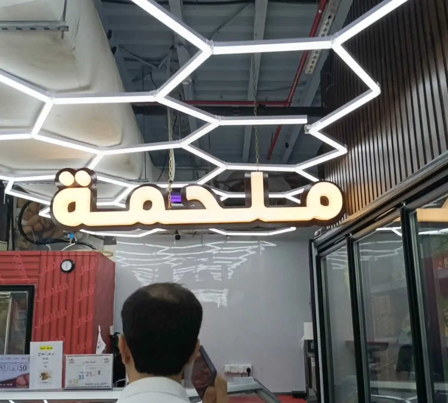 Illuminated storefront sign being installed